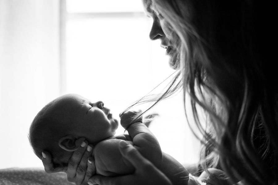 A mother gazing at her newborn baby